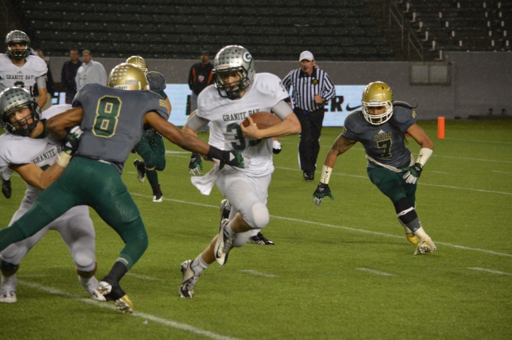 Granite Bay's Taft Partridge (32) runs for some tough yardage against Long Beach Poly in the state's Division I title game. Photo Credit: Ronald Jenkins