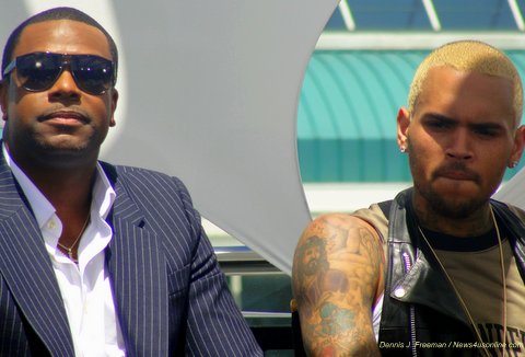 Singer Chris Brown (right) at a 2013 press conference with Chris Tucker, had his domestic clash with Rihanna go global. Photo Credit: Dennis J. Freeman