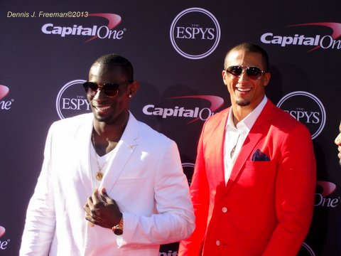 Colin Kaepernick (right) stand out in his red blazer. Photo: Dennis J. Freeman