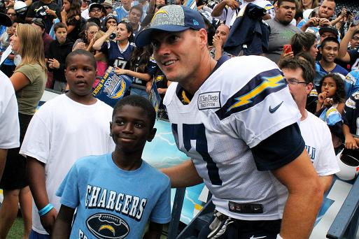 San Diego quarterback Philip Rivers engages a young fan during the team's Fanfest at Qualcomm Stadium on Saturday, August 2. Photo Credit: Dennis J. Freeman/News4usonline.com