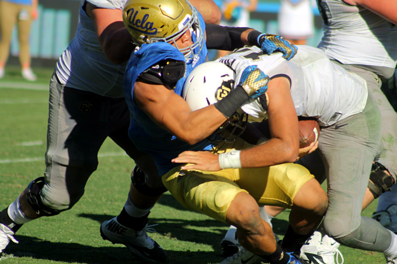 Coming back to earth: A UCLA defender sacks Colorado quarterback Sefo LuFau in the game's waning moments on Saturday, Oct. 31, 2015. Photo by Dennis J. Freeman/News4usonline.com