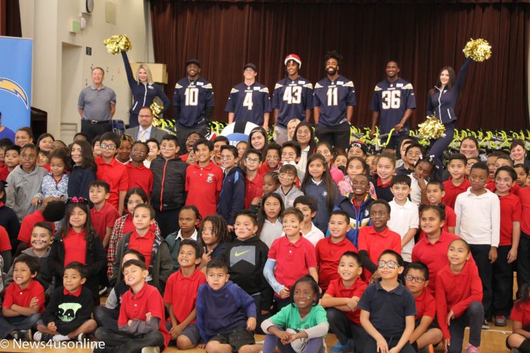 Los Angeles Chargers pass out bikes to students at Cesar Chavez Elementary School in Long Beach, California.