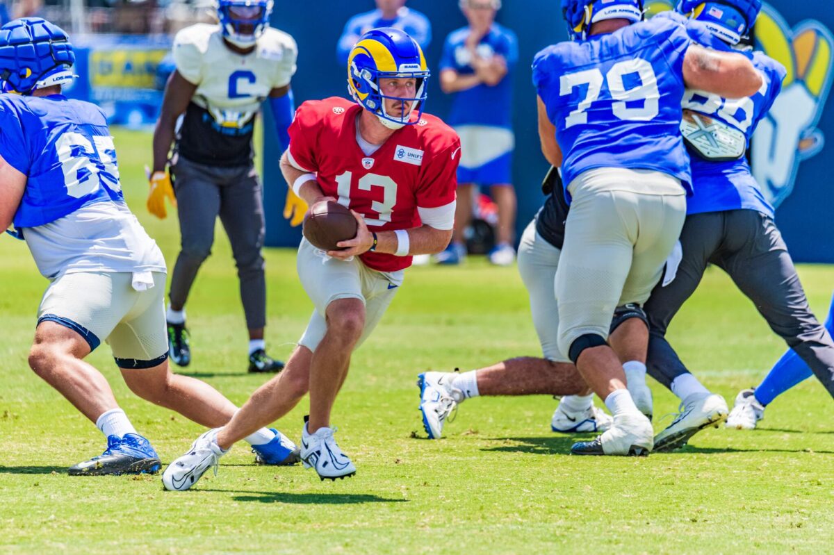 Los Angeles Rams quarterback John Wolford, front, is tackled by