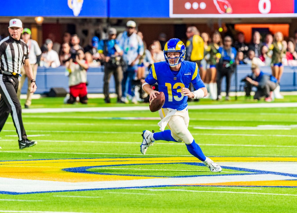 Los Angeles Rams head coach Sean McVay talks to quarterback John Wolford (13)  before an NFL